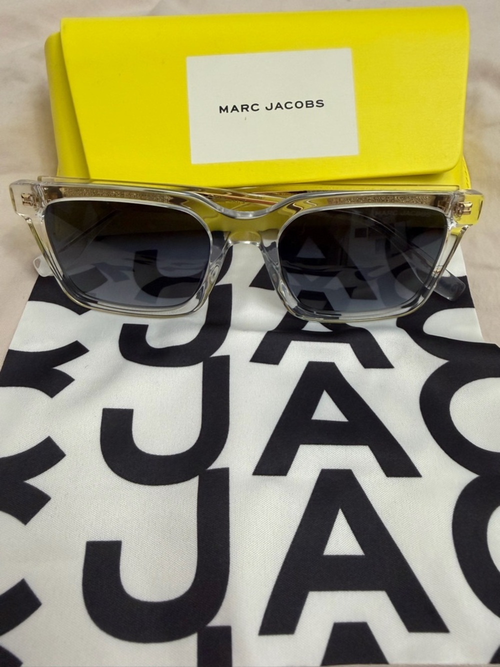 Marc Jacobs Clear Frame Sunglasses with Dark Gray Lenses and Yellow Case